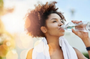 Young healthy woman drinking water