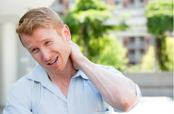 Man dealing with frequent neck and shoulder pain