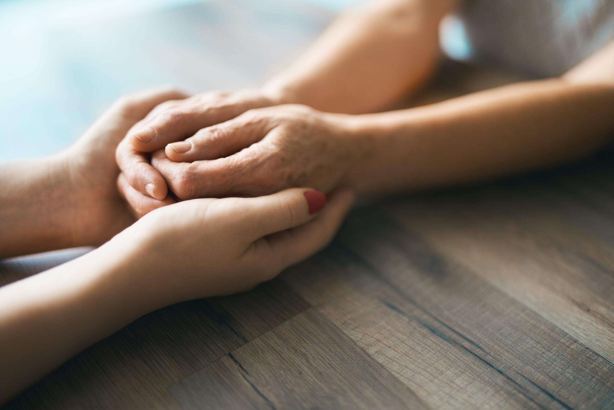 Young woman holding hands with grandma