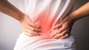 A woman holding her back in pain