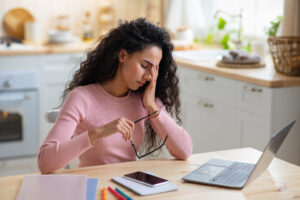 Woman in pain sitting at the table